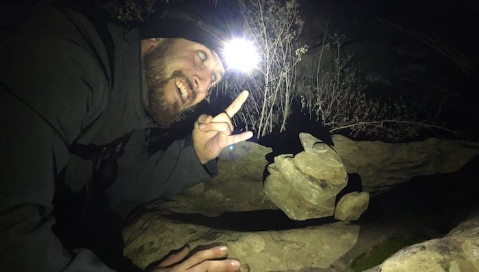 Chase Using His Headlamp To Stack Rocks While Backpacking Northern California