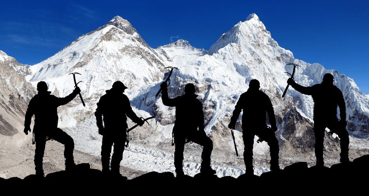 Group of outdoor adventurers rest in the shade while climbing Mount Everest