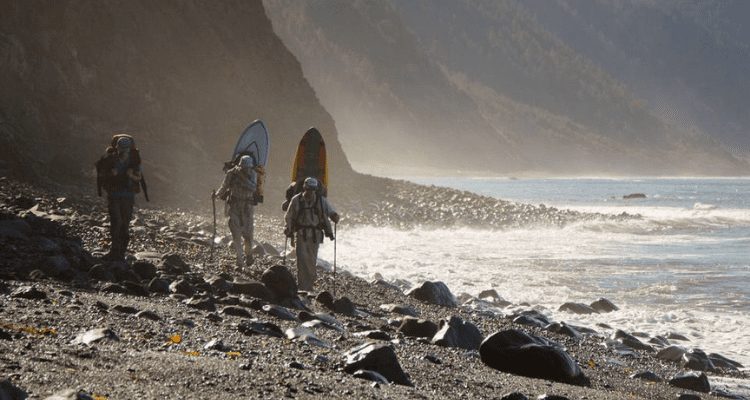 David Aston and friends hiking the lost coast with their surf boards looking for the perfect spot
