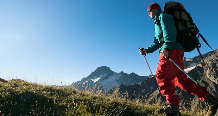 Man hiking on a mountain to lose weight and remain healthy