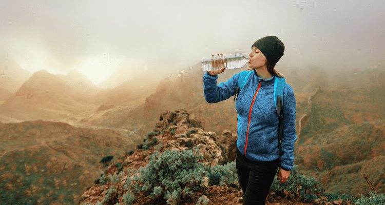 hiker drinking water in the rain