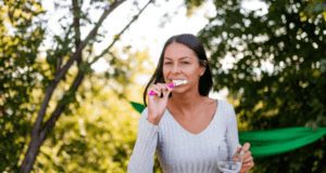 Woman brushing her teeth while camping