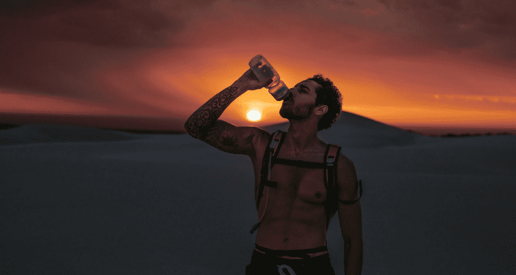 Hiker drinking water during a desert hike