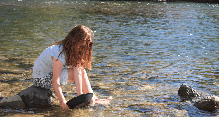 Girl panning for gold nuggets
