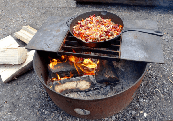 Cooking a healthy dinner over a campfire after a long hike
