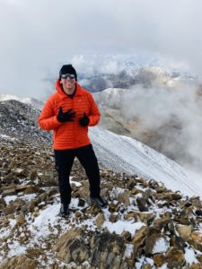 Michael Putnam aka Putty standing atop his 6th peak, Mount Elbert in Colorado