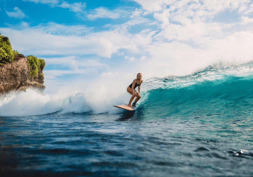 Woman surfing off the coast of Costa Rica